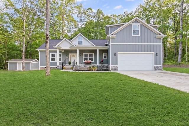 120 Destineys Way, Gruetli Laager, TN 37339 - view of front facade with covered porch, driveway, board and batten siding, a front lawn, and a garage