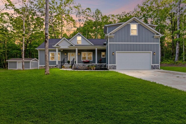 120 Destineys Way, Gruetli Laager, TN 37339 - view of front of home featuring a porch, a yard, driveway, board and batten siding, and a garage