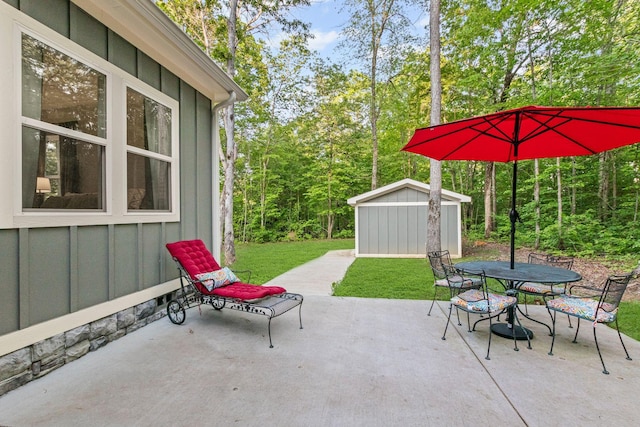 120 Destineys Way, Gruetli Laager, TN 37339 - view of patio / terrace with a storage unit, outdoor dining space, and an outbuilding