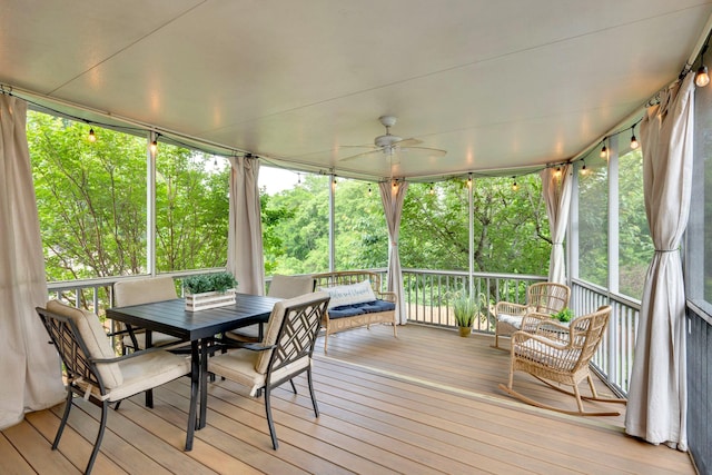 sunroom featuring ceiling fan and outdoor dining area