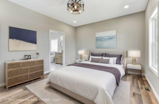 2582 Gap Rd, Altamont, TN 37301 - bedroom featuring multiple windows, wood finished floors, ensuite bath, baseboards, and recessed lighting