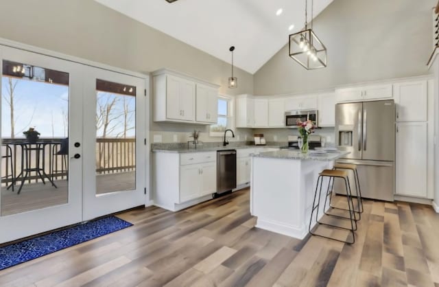 2582 Gap Rd, Altamont, TN 37301 - kitchen with appliances with stainless steel finishes, high vaulted ceiling, white cabinetry, french doors, and a center island