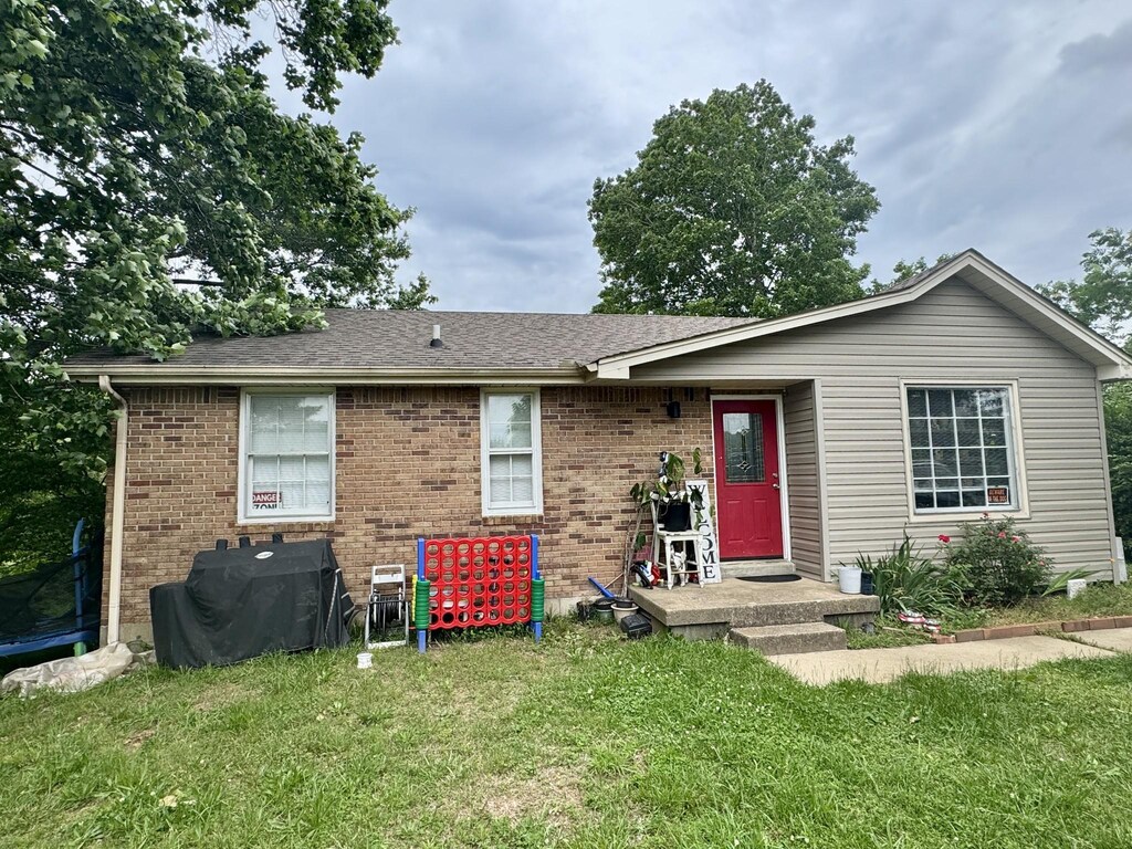 407 Marshall Stuart Dr, Dickson, TN 37055 - view of front of house featuring a front lawn, brick siding, and a shingled roof