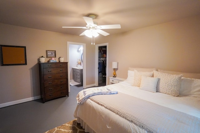 bedroom with a closet, a walk in closet, baseboards, and a ceiling fan