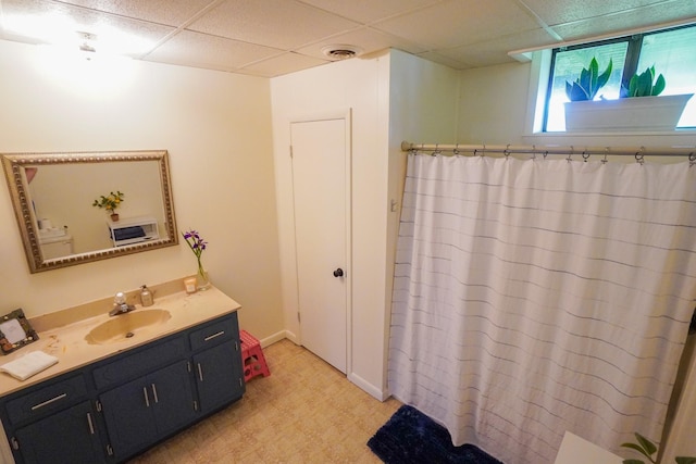 full bathroom featuring a paneled ceiling, vanity, curtained shower, and tile patterned floors