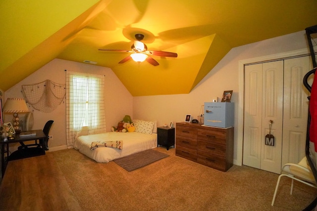 bedroom featuring lofted ceiling, a closet, a ceiling fan, and carpet flooring
