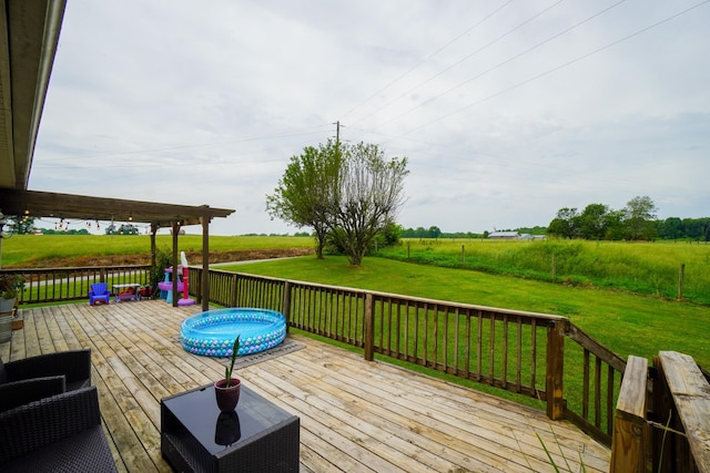 deck with a yard and a view of rural / pastoral area