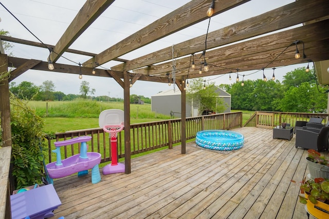 deck with a pergola, outdoor lounge area, and a yard