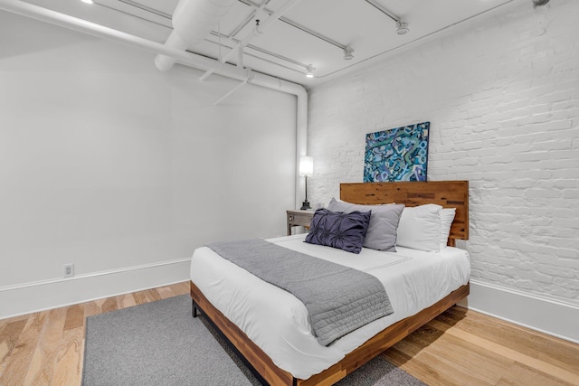 55 E Main St # 208, Chattanooga, TN 37408 - bedroom featuring wood finished floors, baseboards, and track lighting