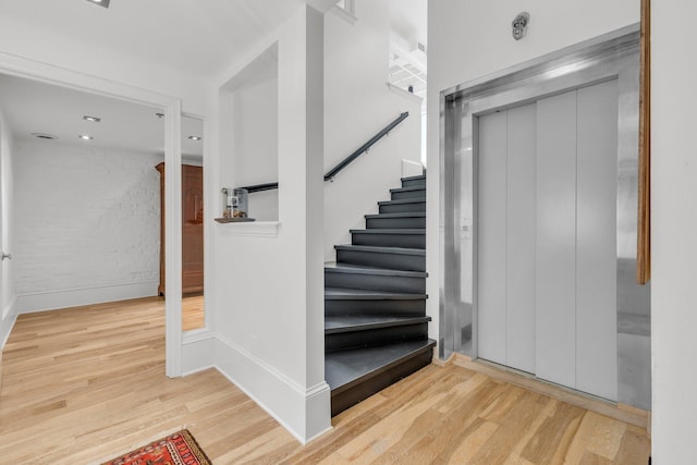 55 E Main St # 208, Chattanooga, TN 37408 - stairs featuring elevator, wood finished floors, and baseboards