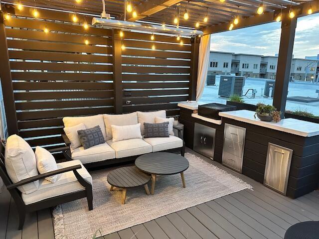 55 E Main St # 208, Chattanooga, TN 37408 - wooden deck with a pergola, an outdoor hangout area, and an outdoor kitchen