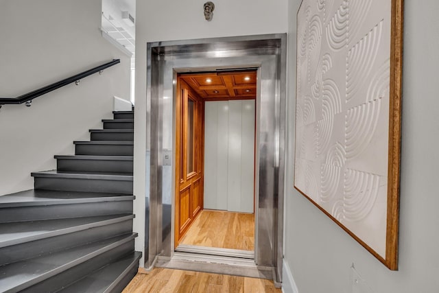 55 E Main St # 208, Chattanooga, TN 37408 - stairs featuring elevator, wood finished floors, and recessed lighting