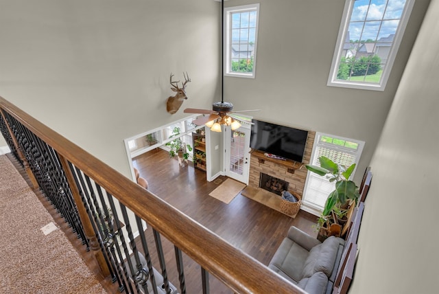 1607 Edgewater Ln, Clarksville, TN 37043 - living room featuring a ceiling fan, a stone fireplace, a towering ceiling, and wood finished floors