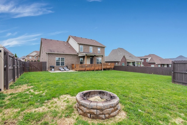 1607 Edgewater Ln, Clarksville, TN 37043 - rear view of property featuring an outdoor fire pit, a wooden deck, a patio area, brick siding, and a residential view