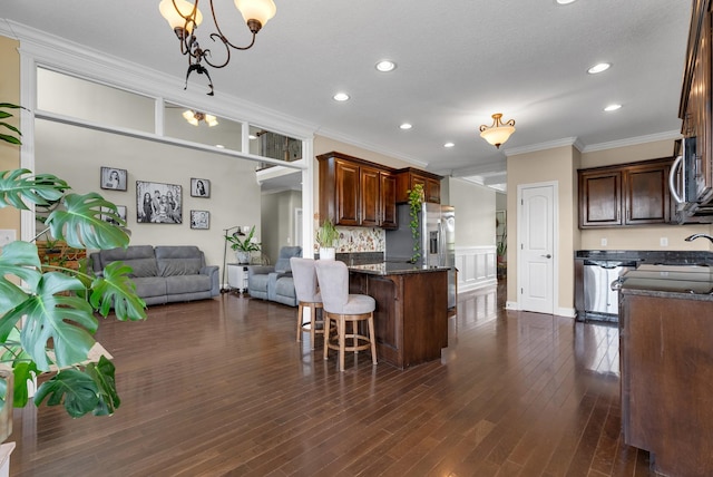 1607 Edgewater Ln, Clarksville, TN 37043 - kitchen featuring crown molding, a chandelier, recessed lighting, open floor plan, and a kitchen bar