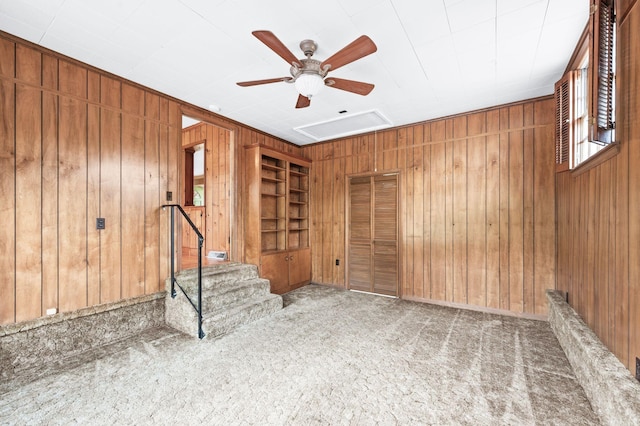 411 Tremont Dr, Murfreesboro, TN 37130 - unfurnished room with wooden walls, a ceiling fan, carpet, and built in shelves