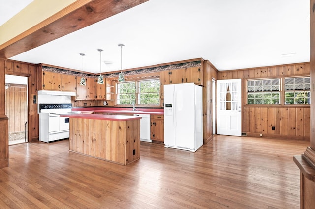 411 Tremont Dr, Murfreesboro, TN 37130 - kitchen with white appliances, wooden walls, wood finished floors, a center island, and under cabinet range hood