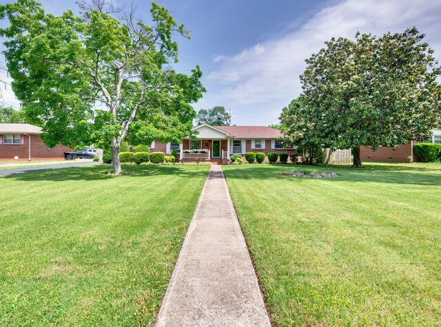 411 Tremont Dr, Murfreesboro, TN 37130 - ranch-style house with a porch, a front lawn, and brick siding