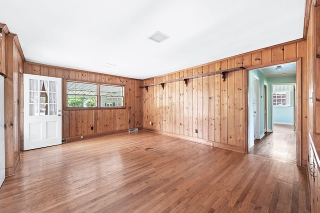 411 Tremont Dr, Murfreesboro, TN 37130 - empty room featuring baseboards, light wood finished floors, wood walls, and crown molding