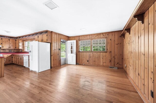411 Tremont Dr, Murfreesboro, TN 37130 - kitchen with white appliances, open shelves, light wood-style flooring, wooden walls, and open floor plan