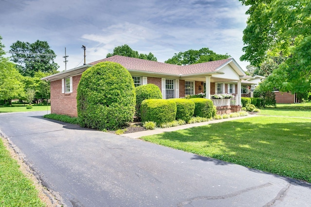 411 Tremont Dr, Murfreesboro, TN 37130 - ranch-style house with brick siding, a front lawn, and covered porch