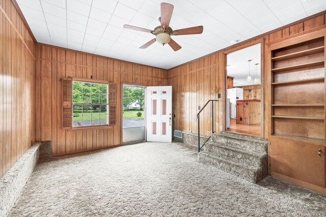411 Tremont Dr, Murfreesboro, TN 37130 - unfurnished living room with carpet, wood walls, a ceiling fan, and built in features