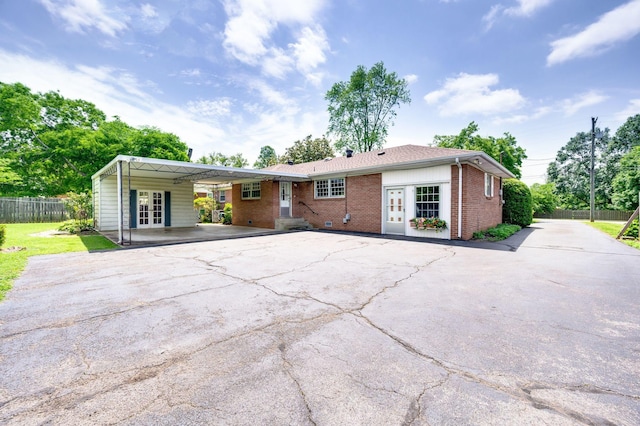 411 Tremont Dr, Murfreesboro, TN 37130 - rear view of house with french doors, asphalt driveway, fence, and brick siding