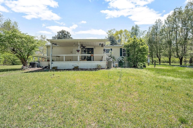 48 Enfield Dr, Beechgrove, TN 37018 - rear view of house with a ceiling fan, a yard, and cooling unit