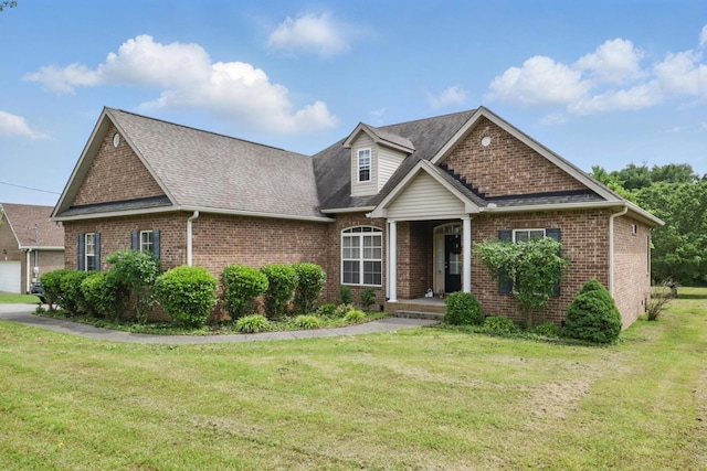 208 Sunnyside Dr, Chapel Hill, TN 37034 - view of front facade featuring brick siding, a front yard, and a shingled roof