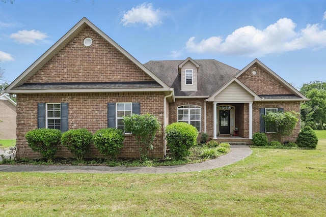208 Sunnyside Dr, Chapel Hill, TN 37034 - view of front of home with brick siding, a front lawn, and a shingled roof