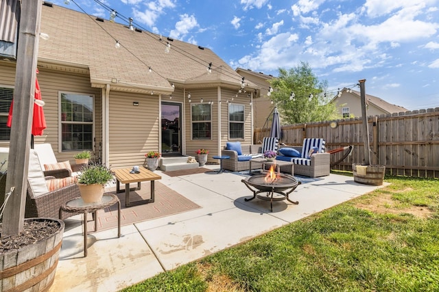 view of patio / terrace featuring a fire pit and fence