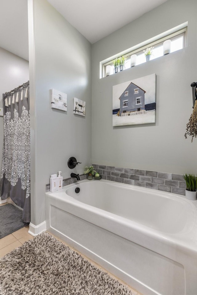 full bathroom with tile patterned floors, a garden tub, and curtained shower