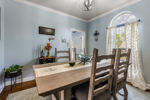 dining room featuring crown molding, a chandelier, baseboards, and wood finished floors