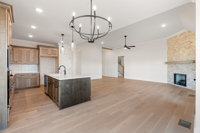 3101 Bluebird Rd, Lebanon, TN 37087 - kitchen featuring a sink, open floor plan, light wood-style flooring, a chandelier, and ornamental molding