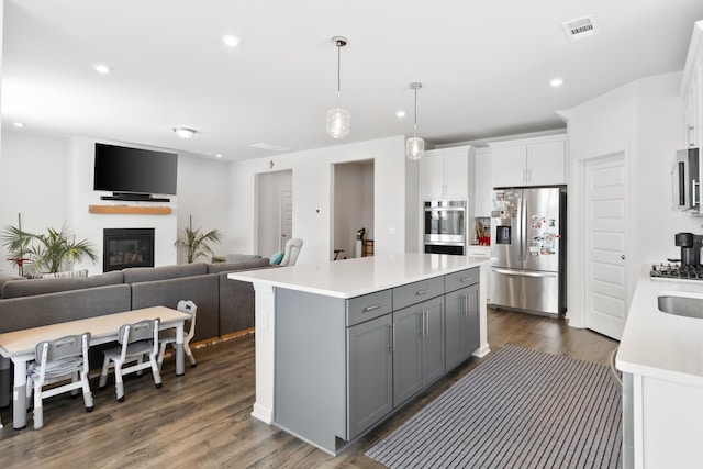 1080 Laurel Valley Ln, Mount Juliet, TN 37122 - kitchen featuring appliances with stainless steel finishes, gray cabinetry, light countertops, open floor plan, and a center island