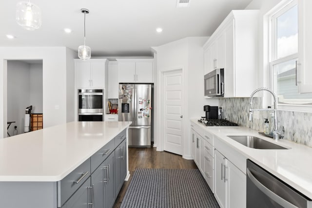 1080 Laurel Valley Ln, Mount Juliet, TN 37122 - kitchen featuring appliances with stainless steel finishes, a sink, gray cabinets, dark wood finished floors, and light countertops