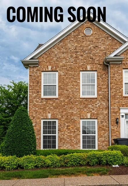 view of side of property featuring brick siding