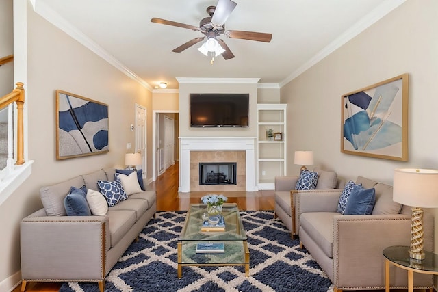 201 Dakota Dr, Spring Hill, TN 37174 - living area featuring crown molding, ceiling fan, wood finished floors, a tile fireplace, and baseboards