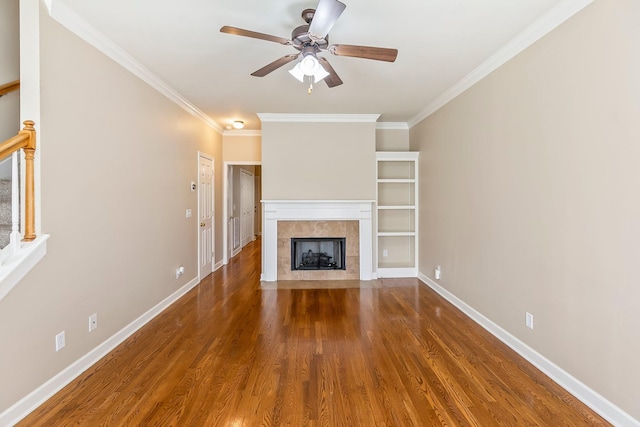 201 Dakota Dr, Spring Hill, TN 37174 - unfurnished living room with ornamental molding, a tile fireplace, wood finished floors, a ceiling fan, and baseboards