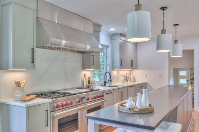 1702 Old Hickory Blvd, Brentwood, TN 37027 - kitchen featuring range with two ovens, wall chimney range hood, tasteful backsplash, light countertops, and recessed lighting