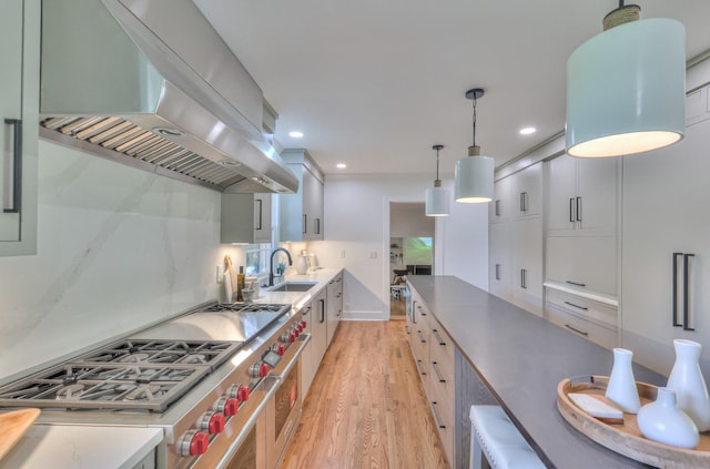 1702 Old Hickory Blvd, Brentwood, TN 37027 - kitchen with extractor fan, stainless steel stove, light wood-style floors, hanging light fixtures, and recessed lighting