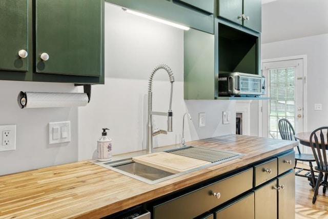 210 Highland Trl, Estill Springs, TN 37330 - kitchen featuring a sink, butcher block countertops, green cabinetry, and light wood-type flooring