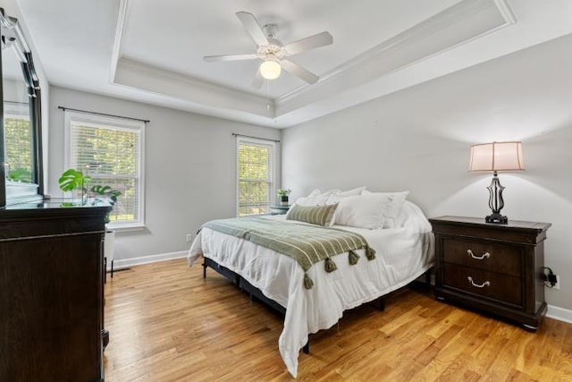 210 Highland Trl, Estill Springs, TN 37330 - bedroom featuring a tray ceiling, light wood-type flooring, baseboards, a ceiling fan, and ornamental molding
