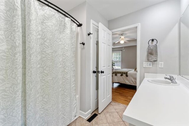 210 Highland Trl, Estill Springs, TN 37330 - ensuite bathroom featuring tile patterned flooring, vanity, shower / bathtub combination with curtain, and a ceiling fan
