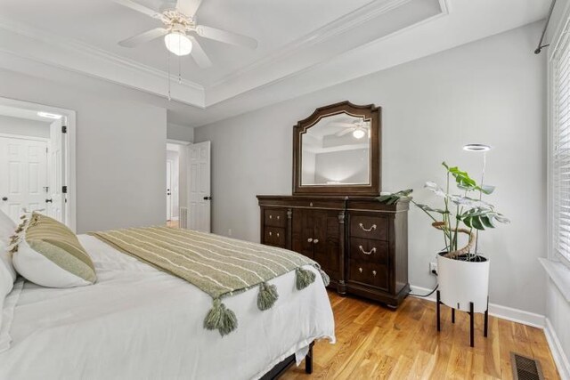 210 Highland Trl, Estill Springs, TN 37330 - bedroom with a raised ceiling, light wood-style flooring, ornamental molding, a ceiling fan, and multiple windows