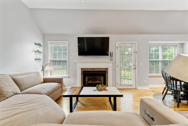 210 Highland Trl, Estill Springs, TN 37330 - living room featuring vaulted ceiling, light wood-style floors, a fireplace, and baseboards
