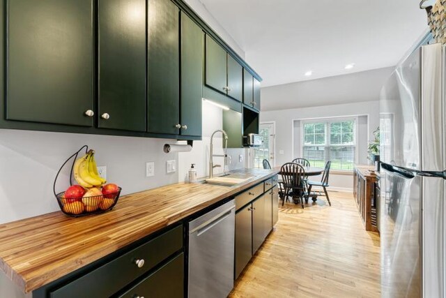 210 Highland Trl, Estill Springs, TN 37330 - kitchen featuring stainless steel appliances, green cabinetry, butcher block counters, a sink, and light wood-type flooring