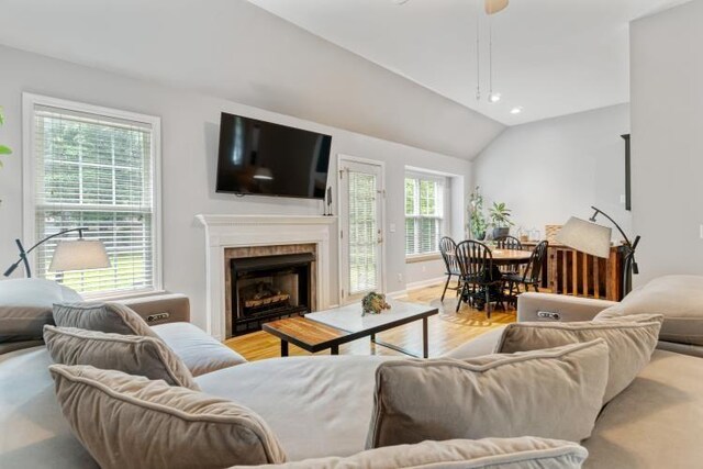 210 Highland Trl, Estill Springs, TN 37330 - living room with light wood-style flooring, lofted ceiling, a fireplace, ceiling fan, and baseboards