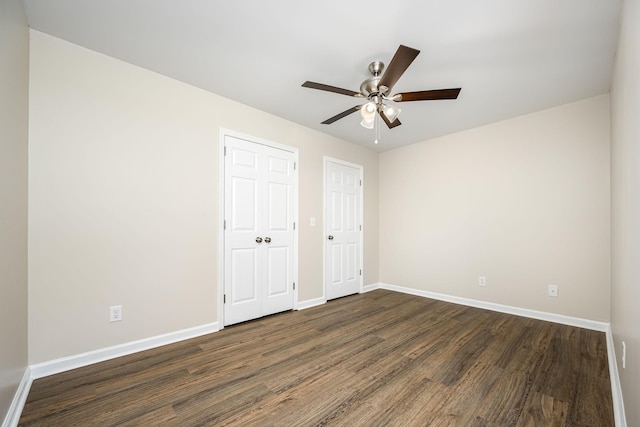 205 Blue Lake Dr, Tullahoma, TN 37388 - unfurnished bedroom featuring dark wood finished floors, baseboards, and a ceiling fan