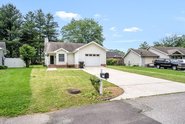 205 Blue Lake Dr, Tullahoma, TN 37388 - ranch-style house with driveway, an attached garage, a chimney, and a gate